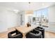 Bright dining room featuring wood table, modern lighting, and large windows with neighborhood views at 556 Monroe St, Denver, CO 80206