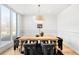 Bright dining room featuring large windows, a stylish light fixture and a modern table at 556 Monroe St, Denver, CO 80206