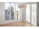 Bright dining area showcases large windows, paneled walls, and a stylish modern light fixture at 556 Monroe St, Denver, CO 80206