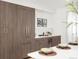 Elegant kitchen with dark wood cabinets, marble backsplash, wine cooler and stainless steel refrigerator at 556 Monroe St, Denver, CO 80206