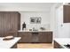 Kitchen featuring custom cabinetry, marble backsplash, white countertops, and built-in wine refrigerator at 556 Monroe St, Denver, CO 80206