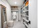 Organized walk-in closet with shelving, hanging rods, and a full-length mirror at 556 Monroe St, Denver, CO 80206