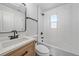 Bathroom with tiled shower-tub, window and updated vanity at 3738 N Eliot St # 2, Denver, CO 80211