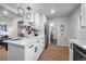 Contemporary kitchen featuring white cabinets, stainless steel appliances, and an open layout to adjacent rooms at 3738 N Eliot St # 2, Denver, CO 80211