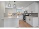 Beautiful kitchen with white cabinetry, stainless steel appliances, a large island, and modern pendant lights at 3738 N Eliot St # 2, Denver, CO 80211