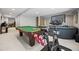 Finished basement featuring a billiards table, seating area, and exercise equipment providing recreational options at 11935 E Lake Ct, Greenwood Village, CO 80111