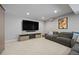 Finished basement featuring a large TV, comfortable seating area, and built-in storage for entertainment at 11935 E Lake Ct, Greenwood Village, CO 80111