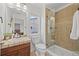 Beautifully updated bathroom featuring glass-enclosed shower, tile flooring, and neutral color palette at 11935 E Lake Ct, Greenwood Village, CO 80111