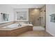 Bathroom featuring a soaking tub and glass enclosed shower at 11935 E Lake Ct, Greenwood Village, CO 80111