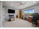Spacious bedroom featuring a ceiling fan, large window, and an open doorway to an adjoining bathroom at 11935 E Lake Ct, Greenwood Village, CO 80111