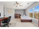Well-lit bedroom with large window offering natural light, complemented by neutral walls and carpet at 11935 E Lake Ct, Greenwood Village, CO 80111