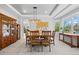 Open dining room with sleek modern lighting, and views of the manicured landscape at 11935 E Lake Ct, Greenwood Village, CO 80111