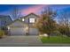Charming stucco home with a three-car garage and well-maintained lawn at 11935 E Lake Ct, Greenwood Village, CO 80111