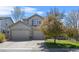 Charming stucco home with a three-car garage and well-maintained lawn at 11935 E Lake Ct, Greenwood Village, CO 80111