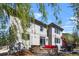Back of house with stone outdoor fireplace, patio furniture, and grill at 11935 E Lake Ct, Greenwood Village, CO 80111