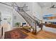Grand foyer entrance with a staircase, bench, and beautiful hardwood floors at 11935 E Lake Ct, Greenwood Village, CO 80111