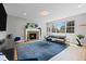 Bright living room with hardwood floors, a fireplace and large windows allowing for lots of light at 11935 E Lake Ct, Greenwood Village, CO 80111