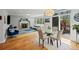 Open living and dining area filled with light, a fireplace and hardwood floors at 11935 E Lake Ct, Greenwood Village, CO 80111