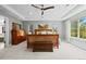 Bright main bedroom featuring a tray ceiling, large windows and ample natural light at 11935 E Lake Ct, Greenwood Village, CO 80111