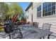 Outdoor dining area with wrought iron table and chairs next to house at 11935 E Lake Ct, Greenwood Village, CO 80111