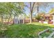 Expansive backyard featuring a well-maintained lawn, storage sheds, and a charming wood fence at 3242 4Th St, Boulder, CO 80304