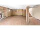 Spacious basement featuring a wood-paneled wall, shelves, and tile flooring at 3242 4Th St, Boulder, CO 80304