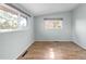 Bright bedroom featuring hardwood floors and two large windows at 3242 4Th St, Boulder, CO 80304