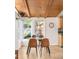 Sunlit dining area features hardwood floors, modern chairs, and a view of the backyard at 3242 4Th St, Boulder, CO 80304