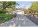 Detached garage with a long driveway and a well-kept lawn, complemented by mature trees at 3242 4Th St, Boulder, CO 80304