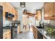 Modern kitchen featuring wooden cabinets, granite countertops, and a view of the dining area at 3242 4Th St, Boulder, CO 80304