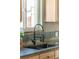 Close-up of a kitchen sink with modern fixtures and stone backsplash, next to a window at 3242 4Th St, Boulder, CO 80304