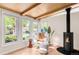 Bright living room with wood beam ceiling, large windows, and modern fireplace at 3242 4Th St, Boulder, CO 80304