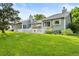 Spacious backyard featuring a well-maintained lawn, white picket fence, and patio with an umbrella at 7 Shetland Ct, Highlands Ranch, CO 80130