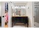 Well-lit bathroom boasts a modern vanity with a vessel sink and an adjacent closet and shower at 7 Shetland Ct, Highlands Ranch, CO 80130