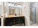 Stylish bathroom features a wood vanity with a vessel sink and a glass-enclosed shower at 7 Shetland Ct, Highlands Ranch, CO 80130
