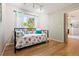 Bright bedroom with hardwood floors and a large window offering plenty of natural light at 7 Shetland Ct, Highlands Ranch, CO 80130