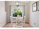 Bright dining area featuring a modern chandelier, wood floors, and natural light at 7 Shetland Ct, Highlands Ranch, CO 80130