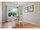 Cozy dining room featuring a round table, four chairs, and a window with a view of the garden at 7 Shetland Ct, Highlands Ranch, CO 80130