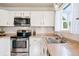 Bright kitchen featuring stainless steel appliances and ample counter space at 7 Shetland Ct, Highlands Ranch, CO 80130