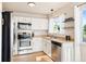 Well-lit kitchen boasts stainless steel appliances and ample cabinet space at 7 Shetland Ct, Highlands Ranch, CO 80130