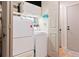 Well-equipped laundry room with modern washer and dryer units, cabinets, and a folding area at 7 Shetland Ct, Highlands Ranch, CO 80130