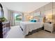 Comfortable main bedroom with a large window, panel wall, and neutral decor at 7 Shetland Ct, Highlands Ranch, CO 80130