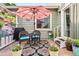 Charming patio area with comfortable seating, a patio umbrella, and decorative plants at 7 Shetland Ct, Highlands Ranch, CO 80130