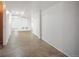 Basement hallway with tile flooring and white walls, connecting different areas of the lower level at 7659 S Holland Way, Littleton, CO 80128