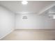 Basement room with white walls and carpet, offering a blank canvas for personalization at 7659 S Holland Way, Littleton, CO 80128