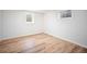 Basement room with natural light and wood-look flooring, a versatile space for various activities at 7659 S Holland Way, Littleton, CO 80128