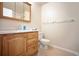 Bathroom features a beautiful wooden vanity, toilet, and medicine cabinet at 7659 S Holland Way, Littleton, CO 80128