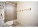 Simple bathroom featuring shower with sliding glass door and bronze towel racks at 7659 S Holland Way, Littleton, CO 80128