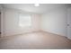 Bright bedroom featuring new carpet and natural light from a window at 7659 S Holland Way, Littleton, CO 80128