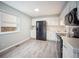 Updated kitchen features black appliances, white cabinetry, and modern flooring at 7659 S Holland Way, Littleton, CO 80128